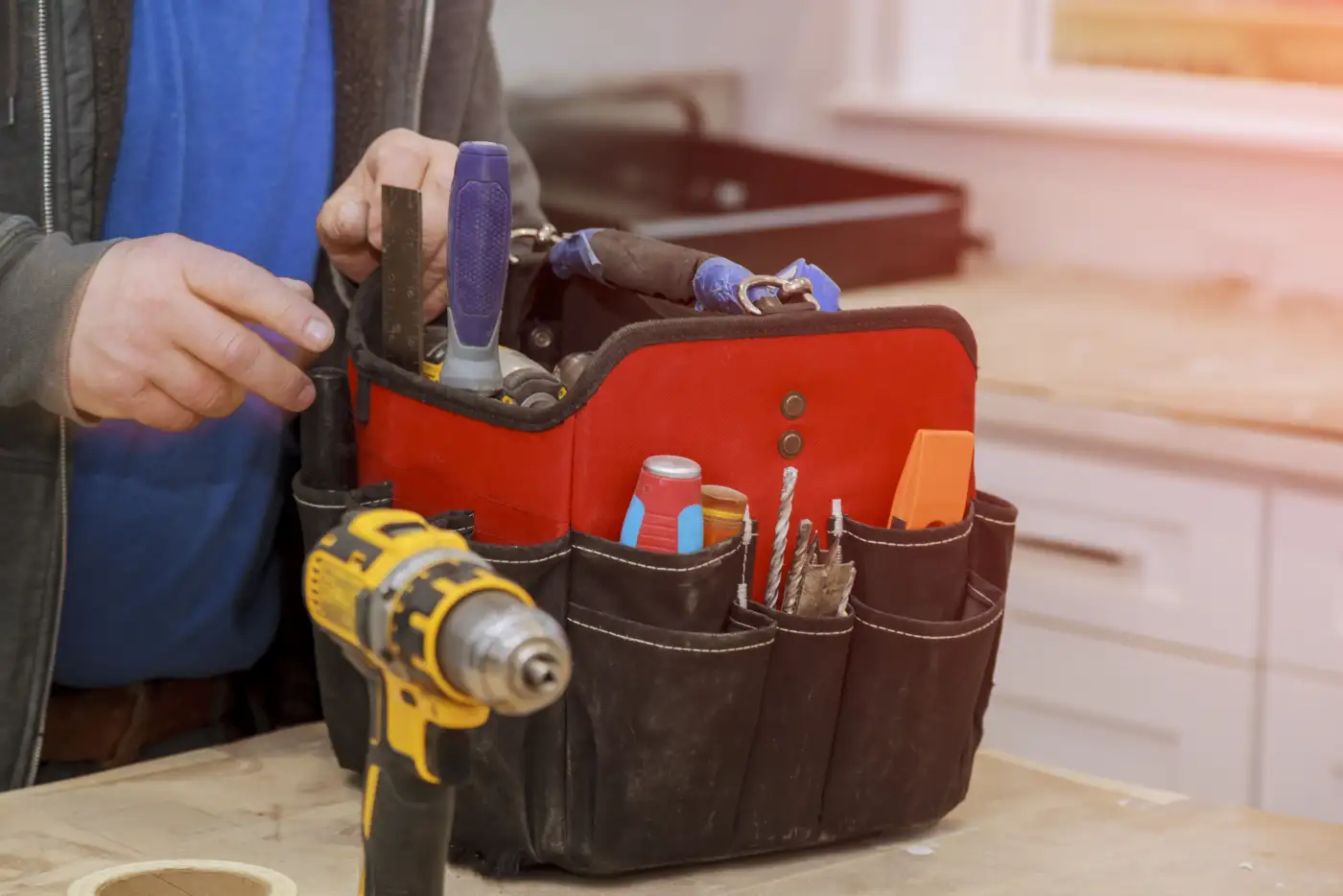 A tradesperson's tool bag with hand tools