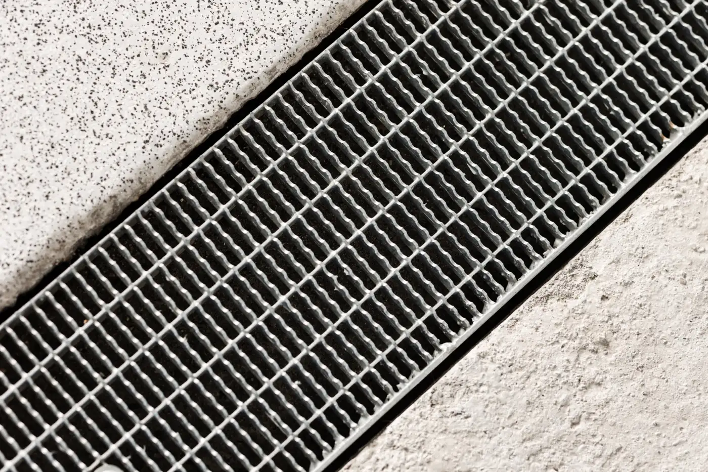 An outdoor drainage channel and grate