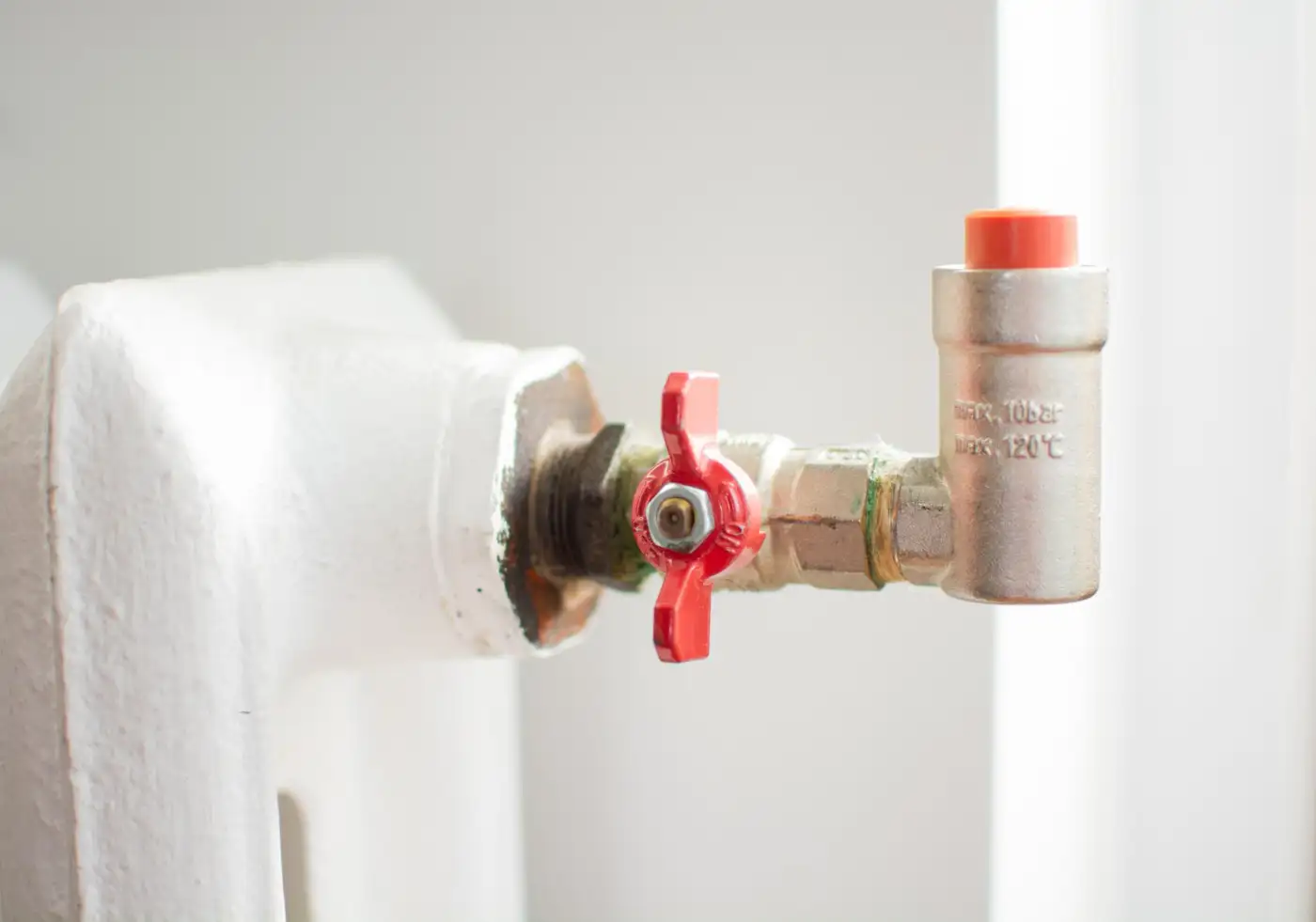 A wall-mounted boiler pressure gauge reading below the normal range