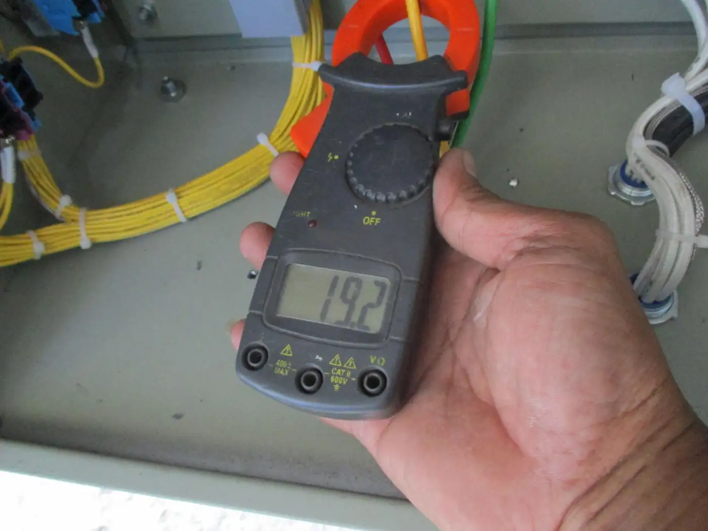 A qualified electrician carrying out an EICR test on a domestic installation