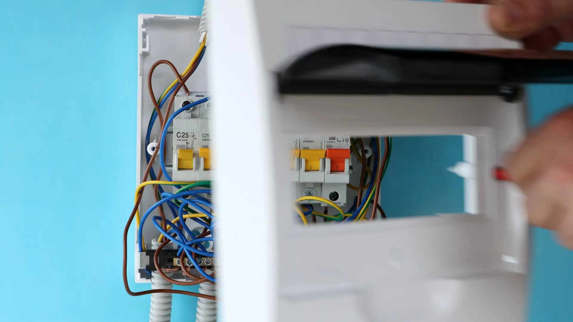 An electrician installing a modern consumer unit during a house rewire