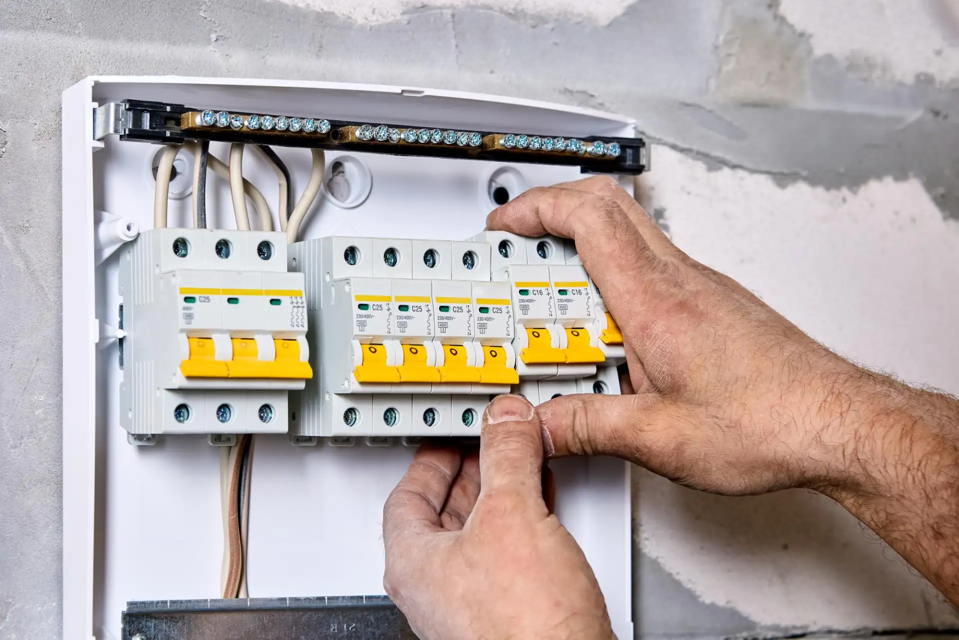 An engineer inspecting a domestic consumer unit in a shared house on the Isle of Man