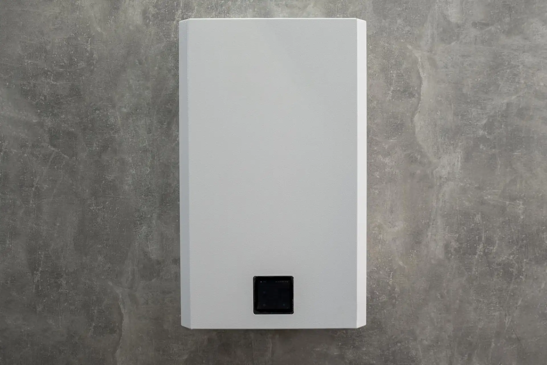 A newly installed wall-mounted gas combi boiler being commissioned by an engineer