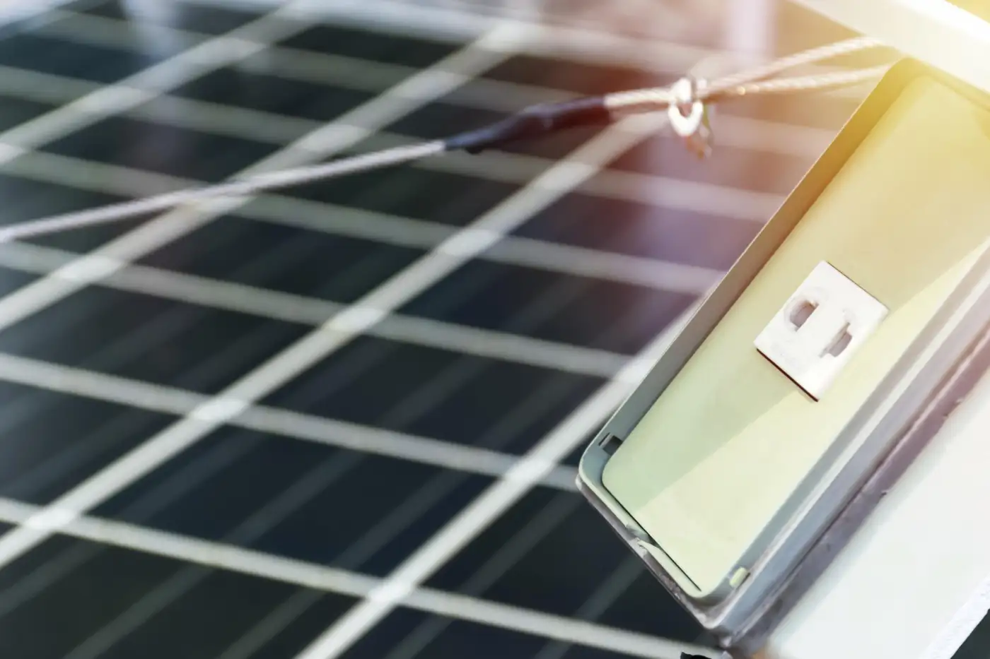 Close-up of a photovoltaic solar panel with a plug socket connection